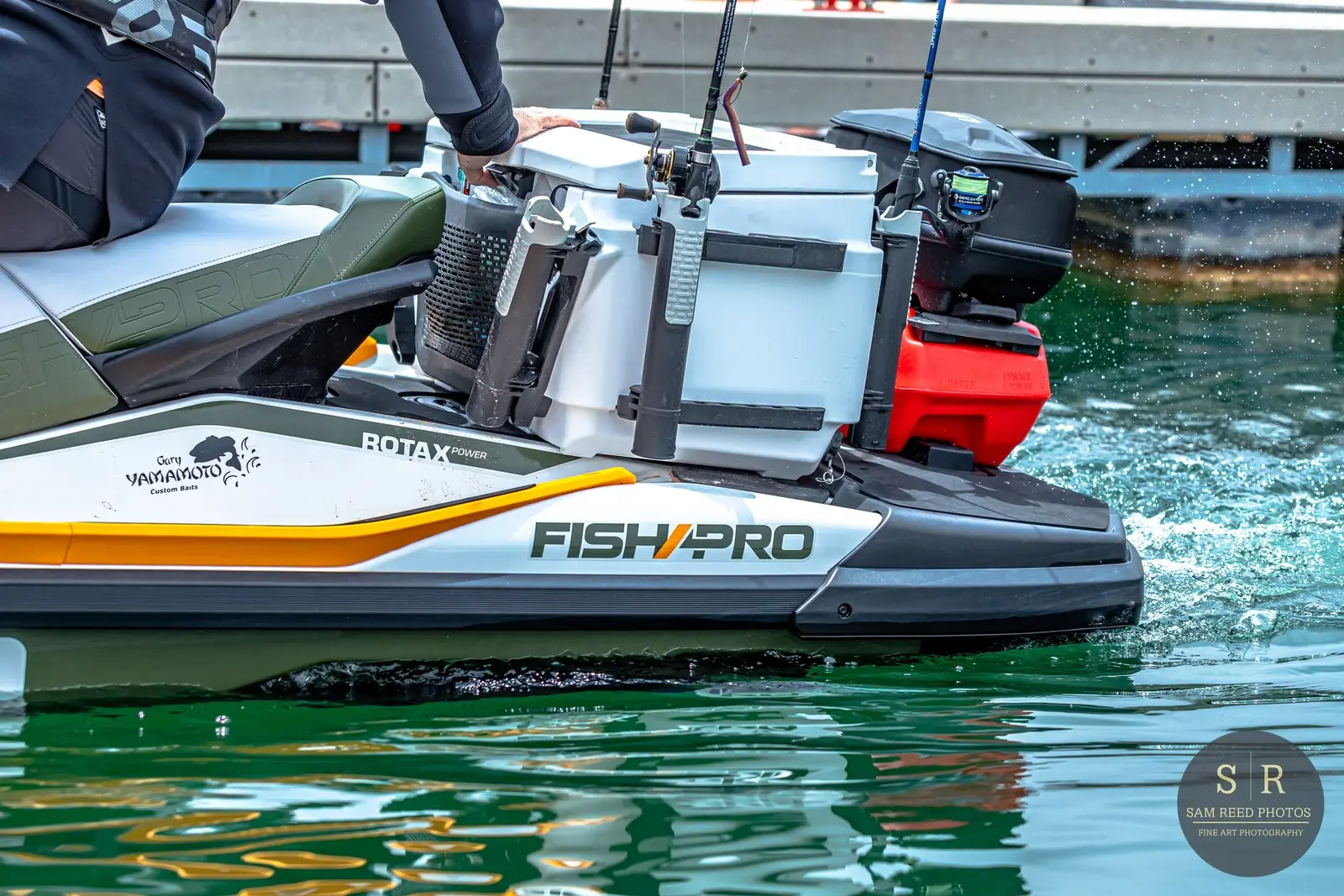 Close-up of a fishing boat with fishing gear and supplies, on green water.