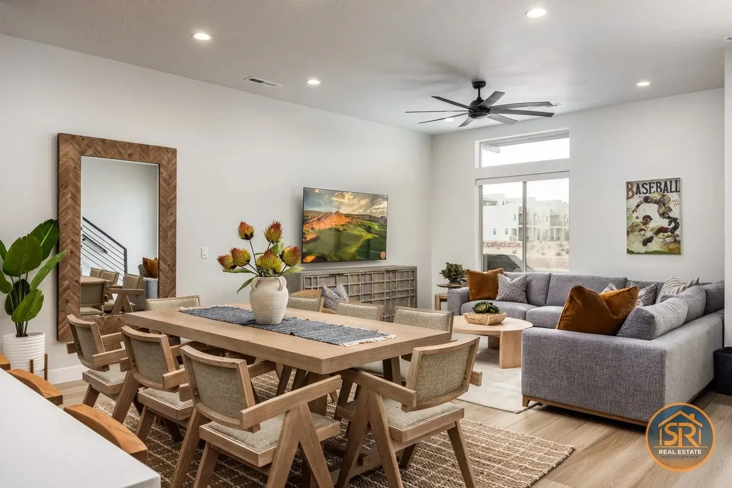 Connected dining and living areas with a sofa, dining table, and open circulation.