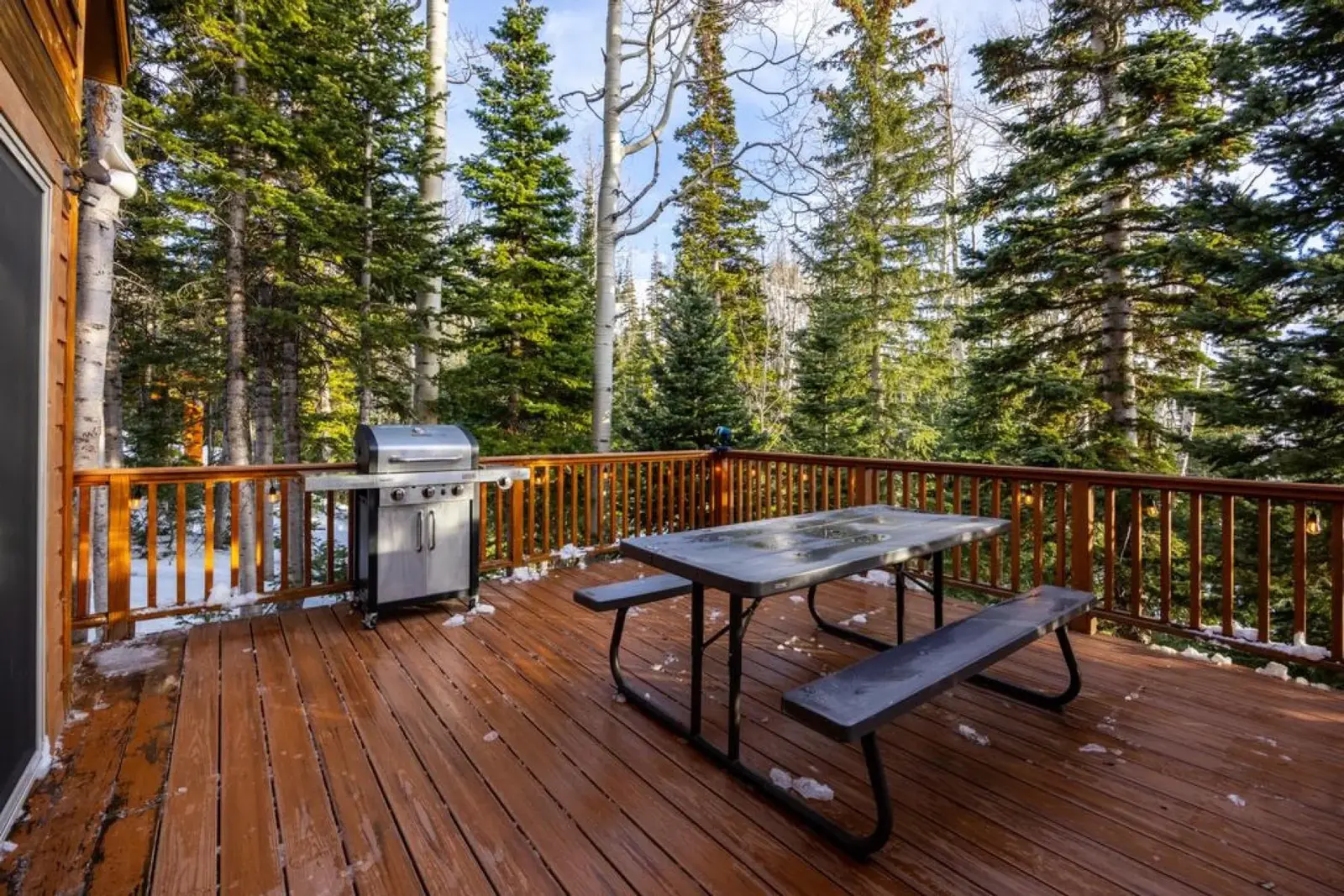 Brian Head — Deck dining area and grill among evergreens