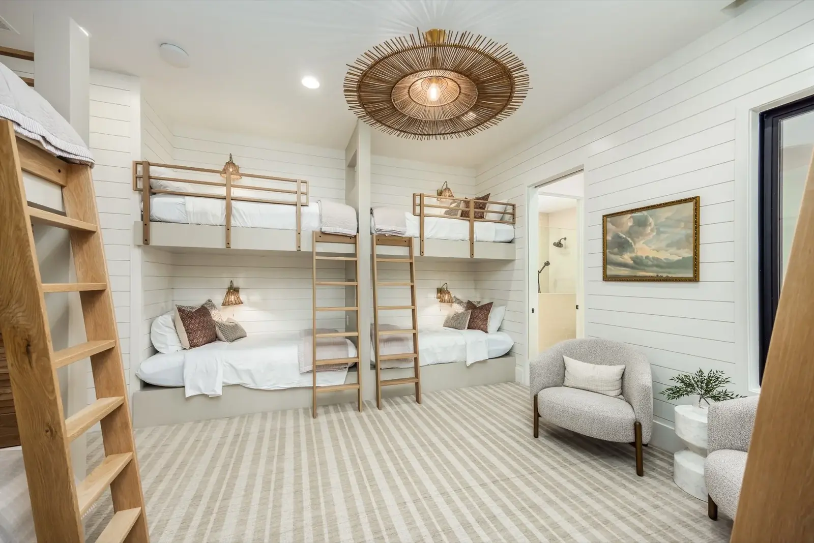 The Oasis Utah — Bunk room with light wood beds and lounge seating