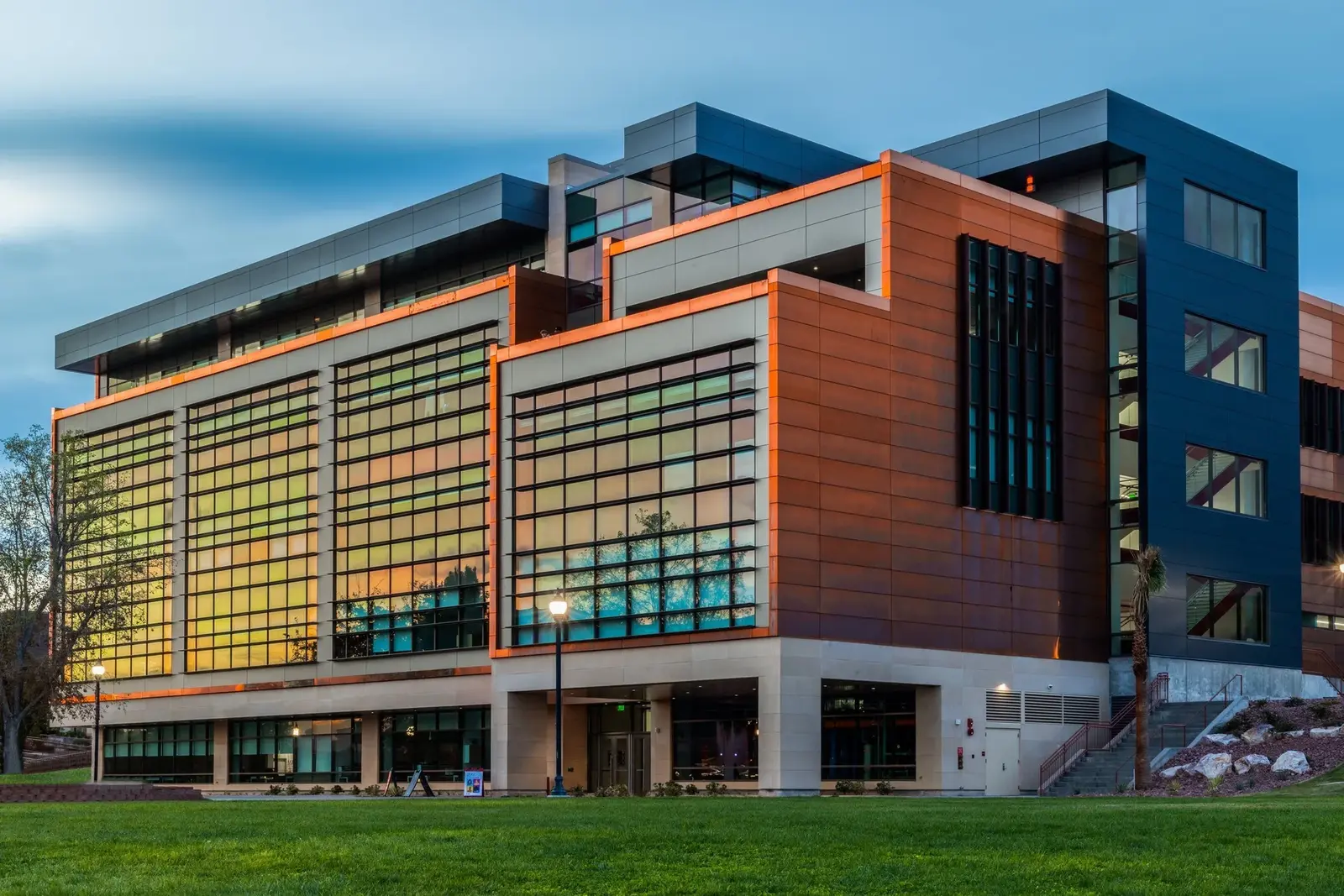 Utah Tech SET building exterior at dusk with warm light behind its gridded glass facade.