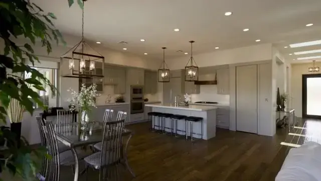 Still from Sam Reed property video showing a kitchen and adjoining living space