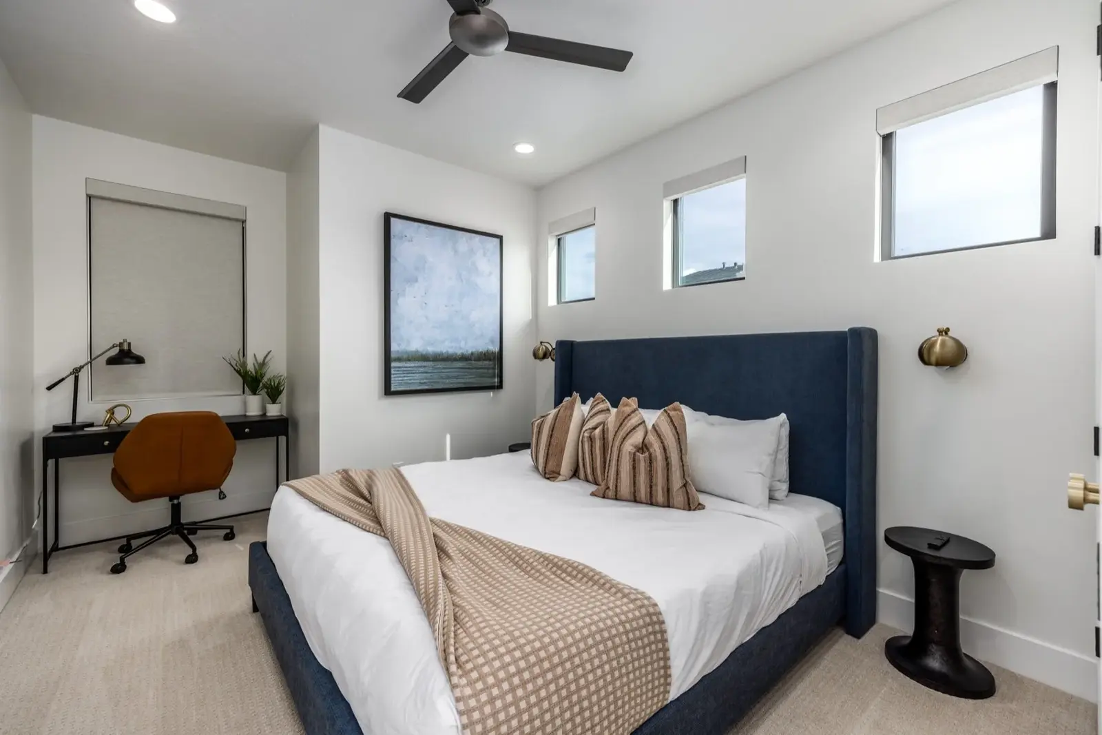 Lula Bay — Bright bedroom with blue upholstered headboard