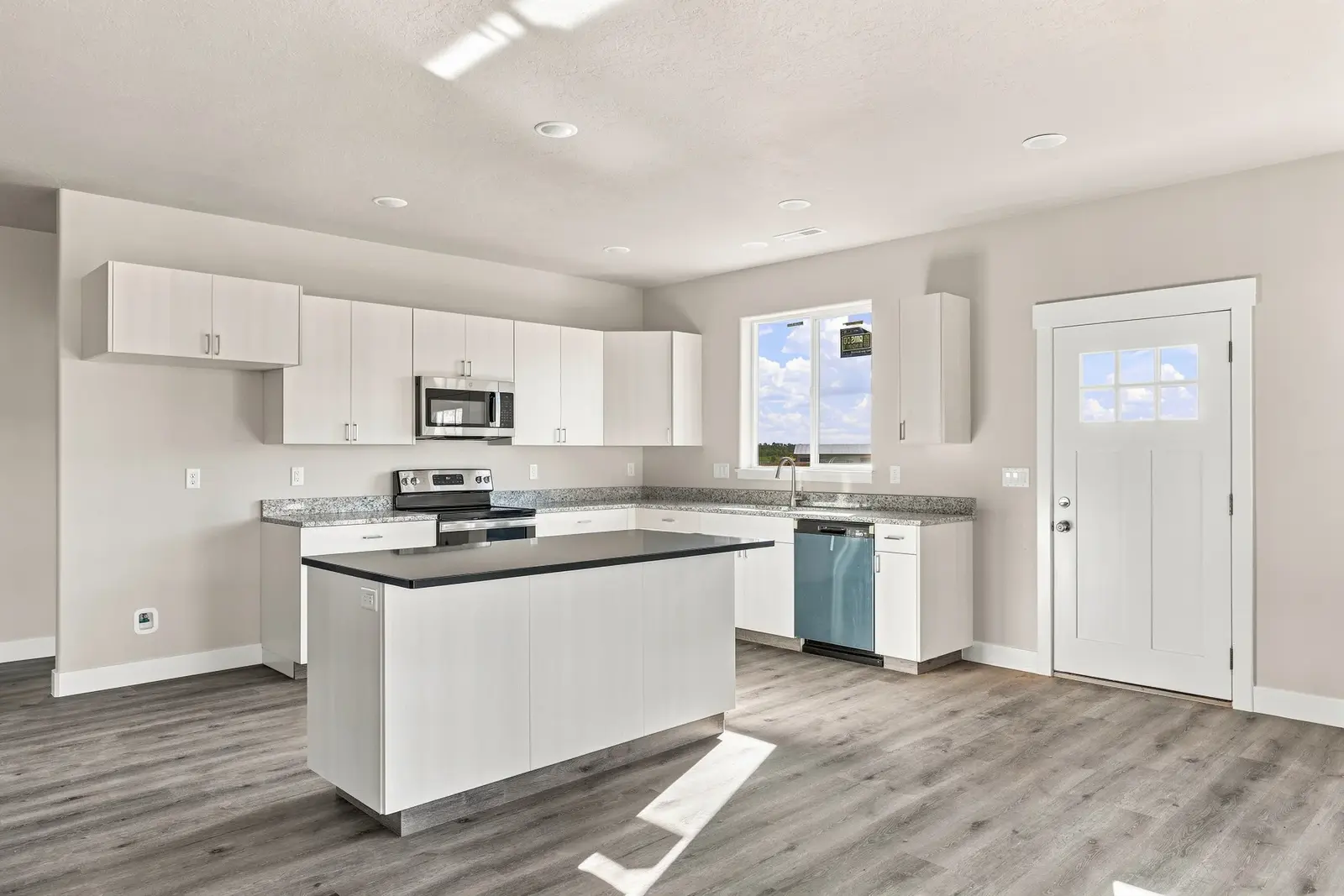 Kitchen with white cabinets and a central island