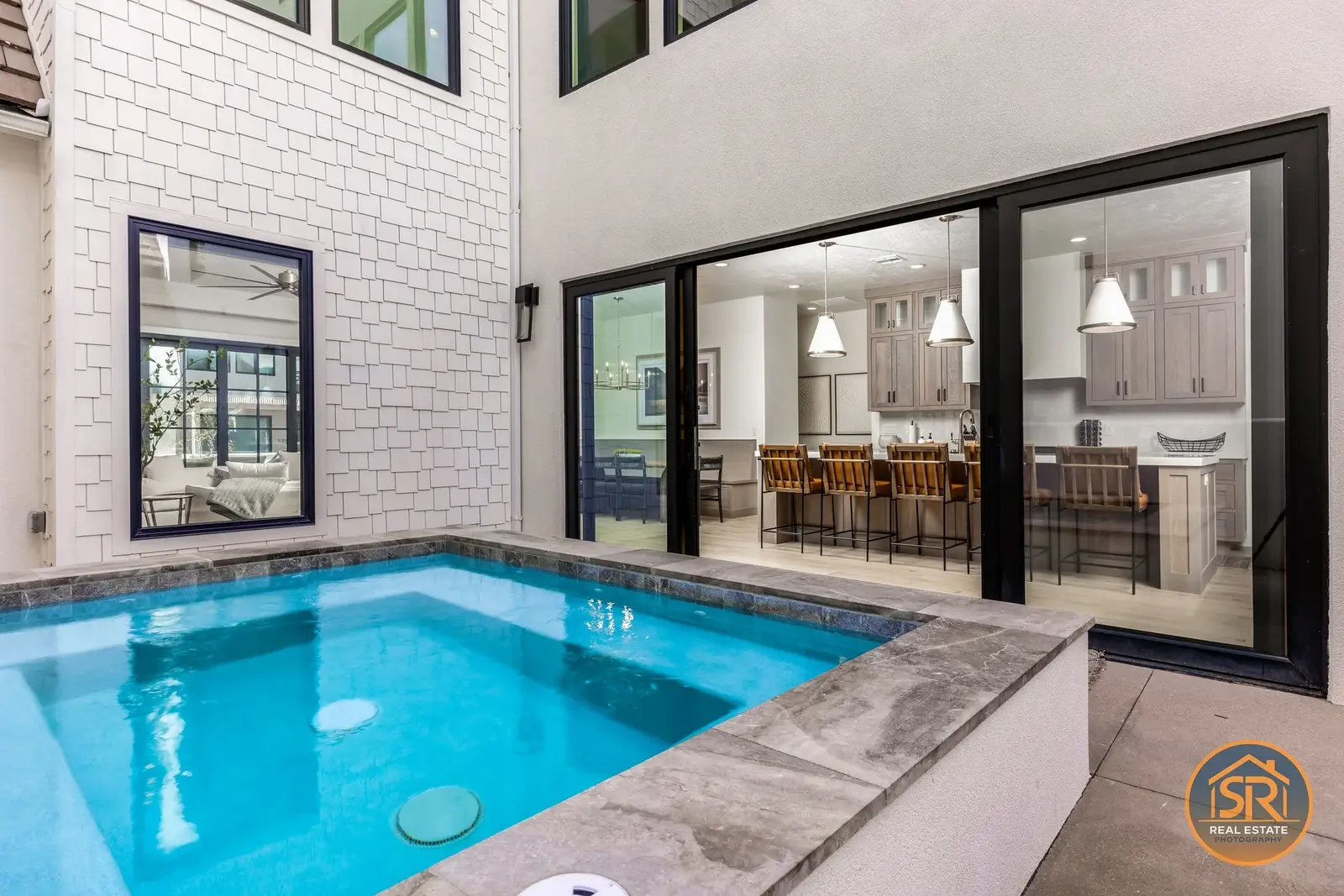 Courtyard pool beside an open living area — from Sam Reed’s photography portfolio