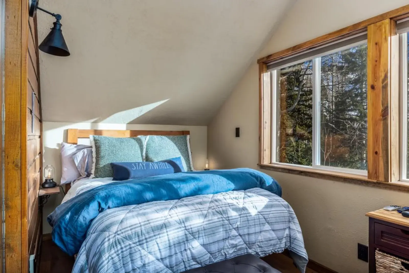 Brian Head — Blue-bedded guest room beside a woodland window
