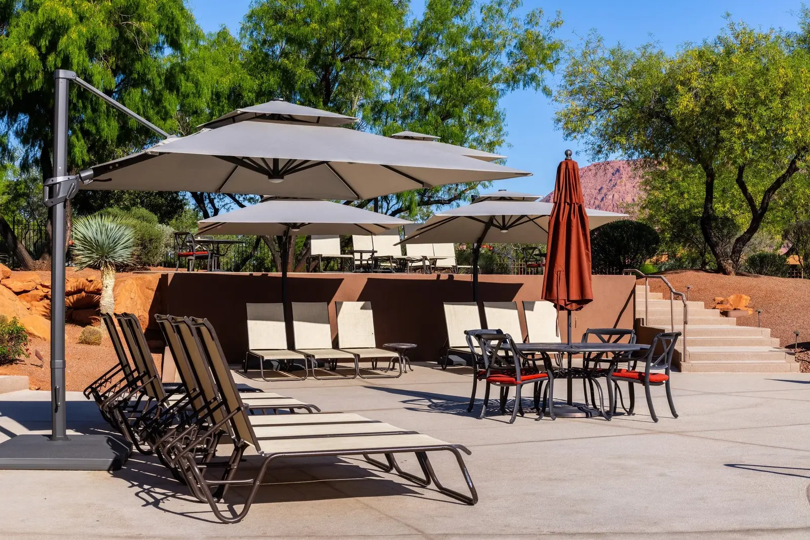 Outdoor terrace with umbrellas and lounge seating at Entrada