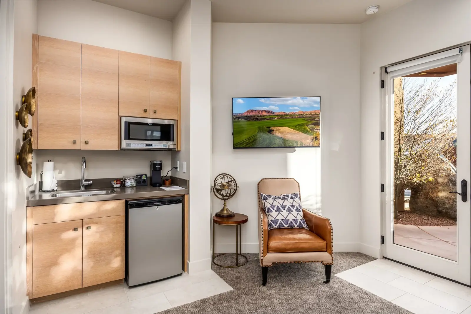Guest suite kitchenette beside a glass patio door at The Inn at Entrada