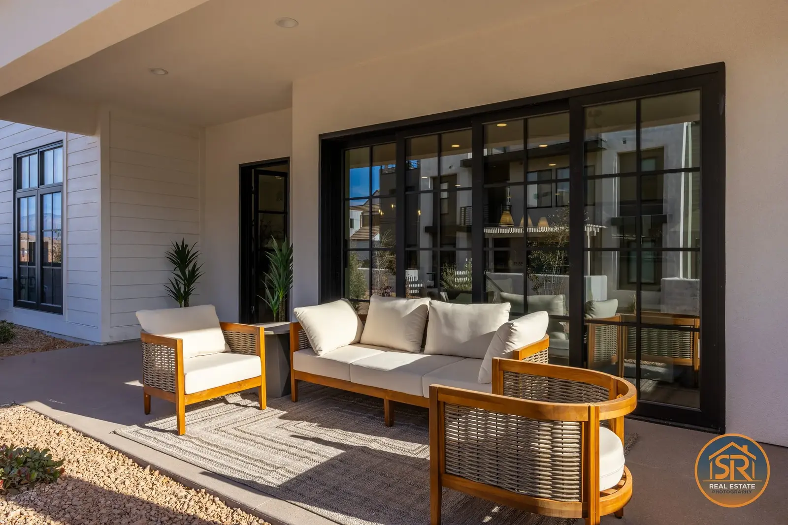 Outdoor seating beneath a covered patio beside sliding glass doors — from Sam Reed’s photography portfolio