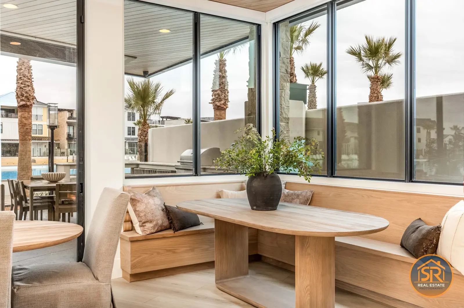 Wood dining nook beside large corner windows — from Sam Reed’s photography portfolio