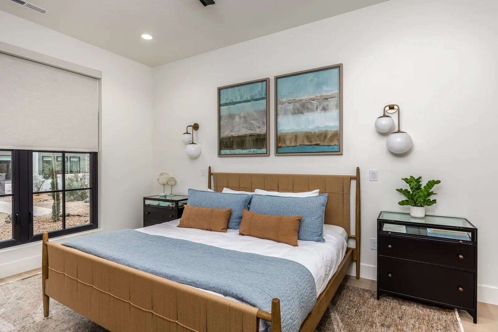Bedroom with a wood bed frame and blue bedding at Lula Bay