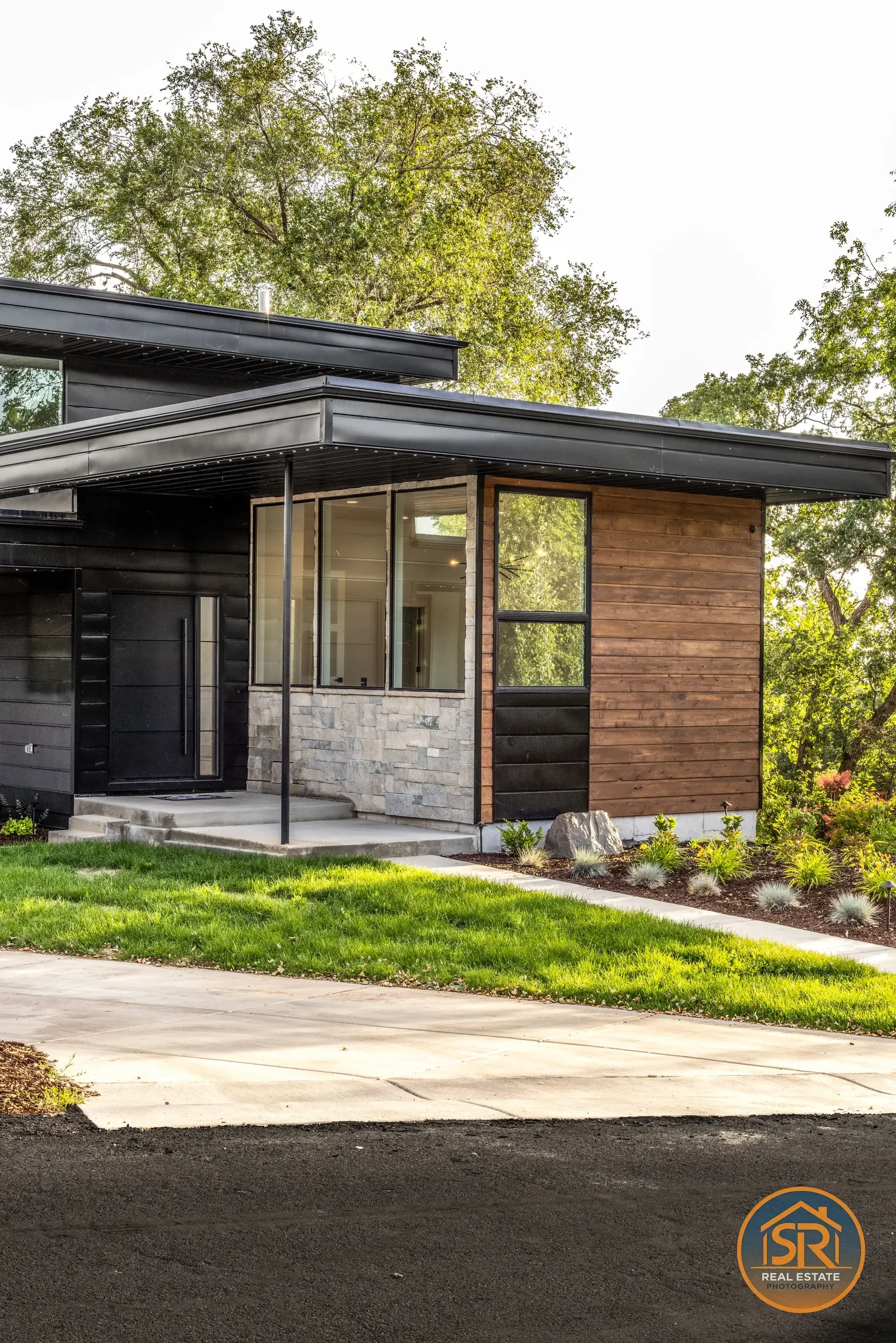 Modern home with wood siding and stone walls — from Sam Reed’s photography portfolio