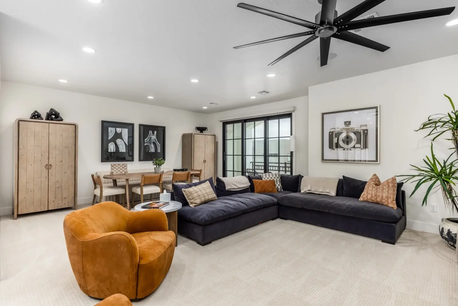 Lula Bay — Lounge with a dark sectional and amber armchair