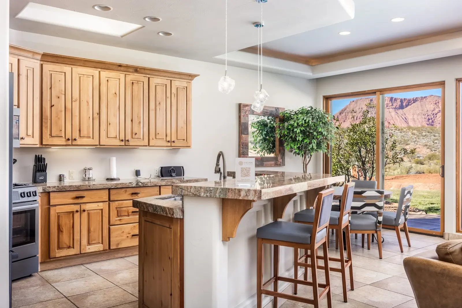 Kitchen with wood cabinetry and a breakfast bar at The Inn at Entrada