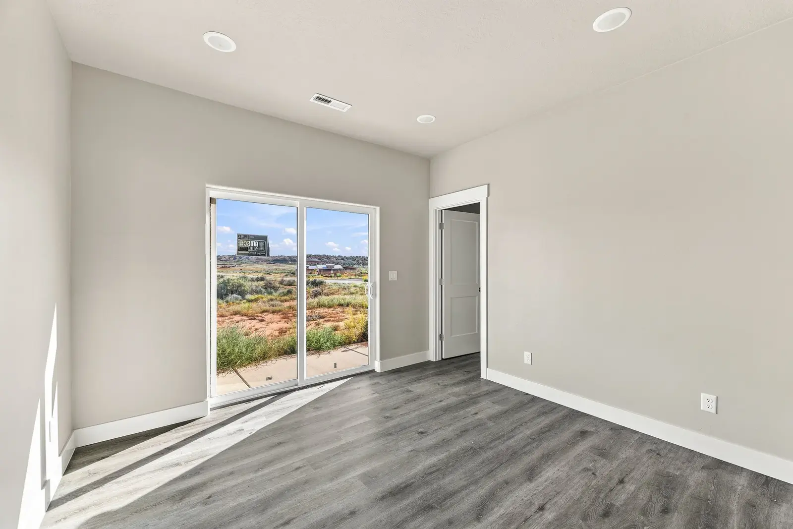 Unfurnished bedroom with sliding glass doors
