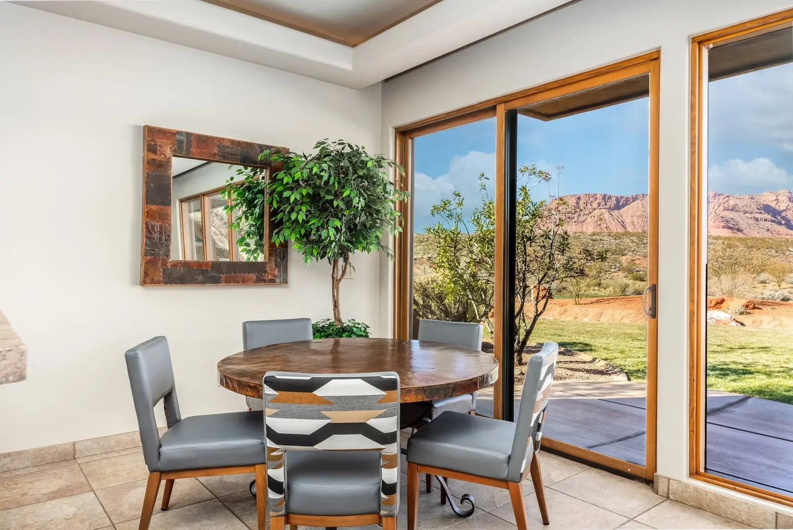 Dining nook beside corner windows overlooking desert landscaping at The Inn at Entrada