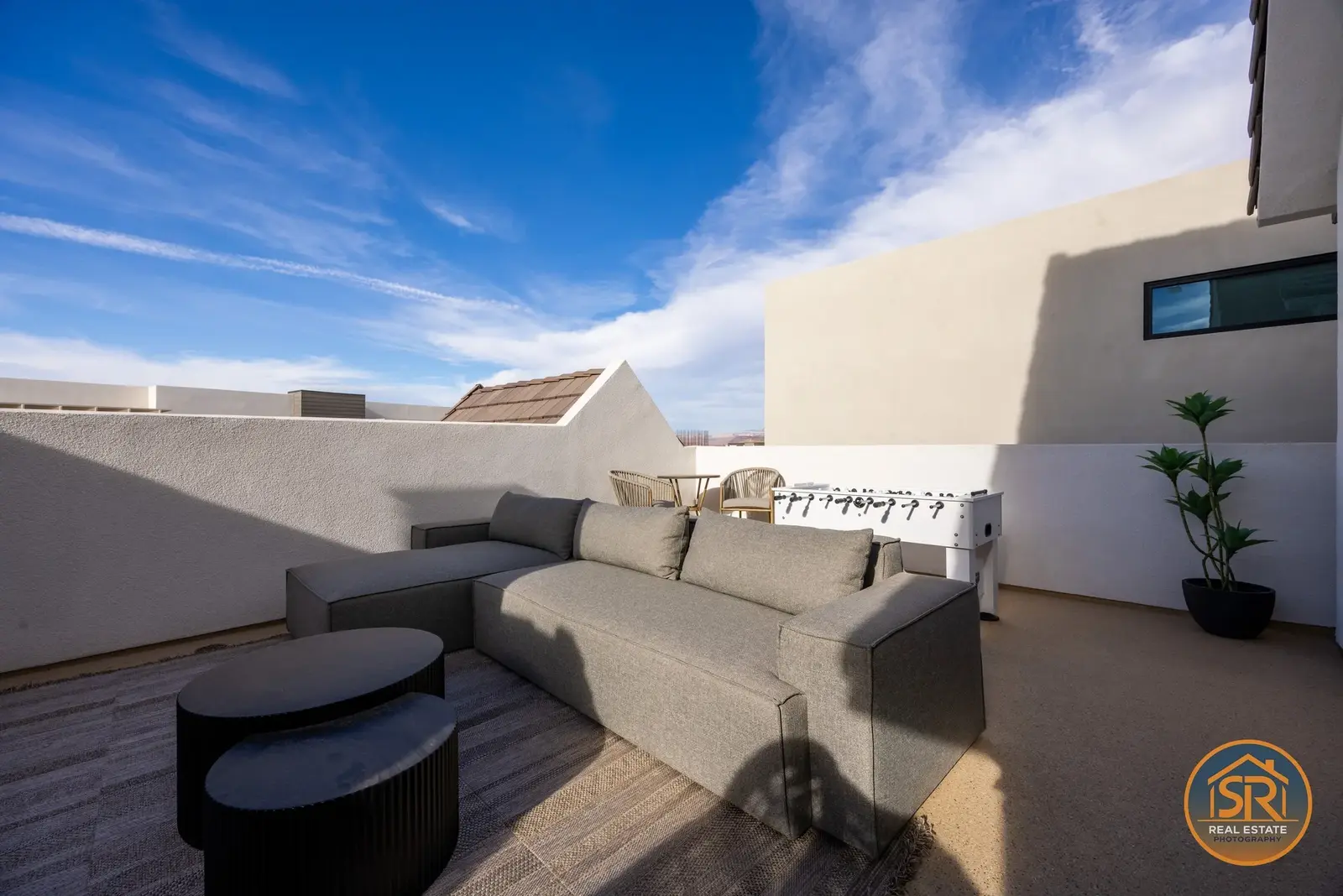 Outdoor lounge with sectional seating and fireplace — from Sam Reed’s photography portfolio