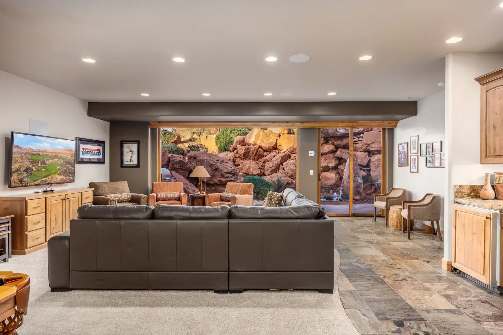 Spacious living room opening toward a red-rock patio at The Inn at Entrada