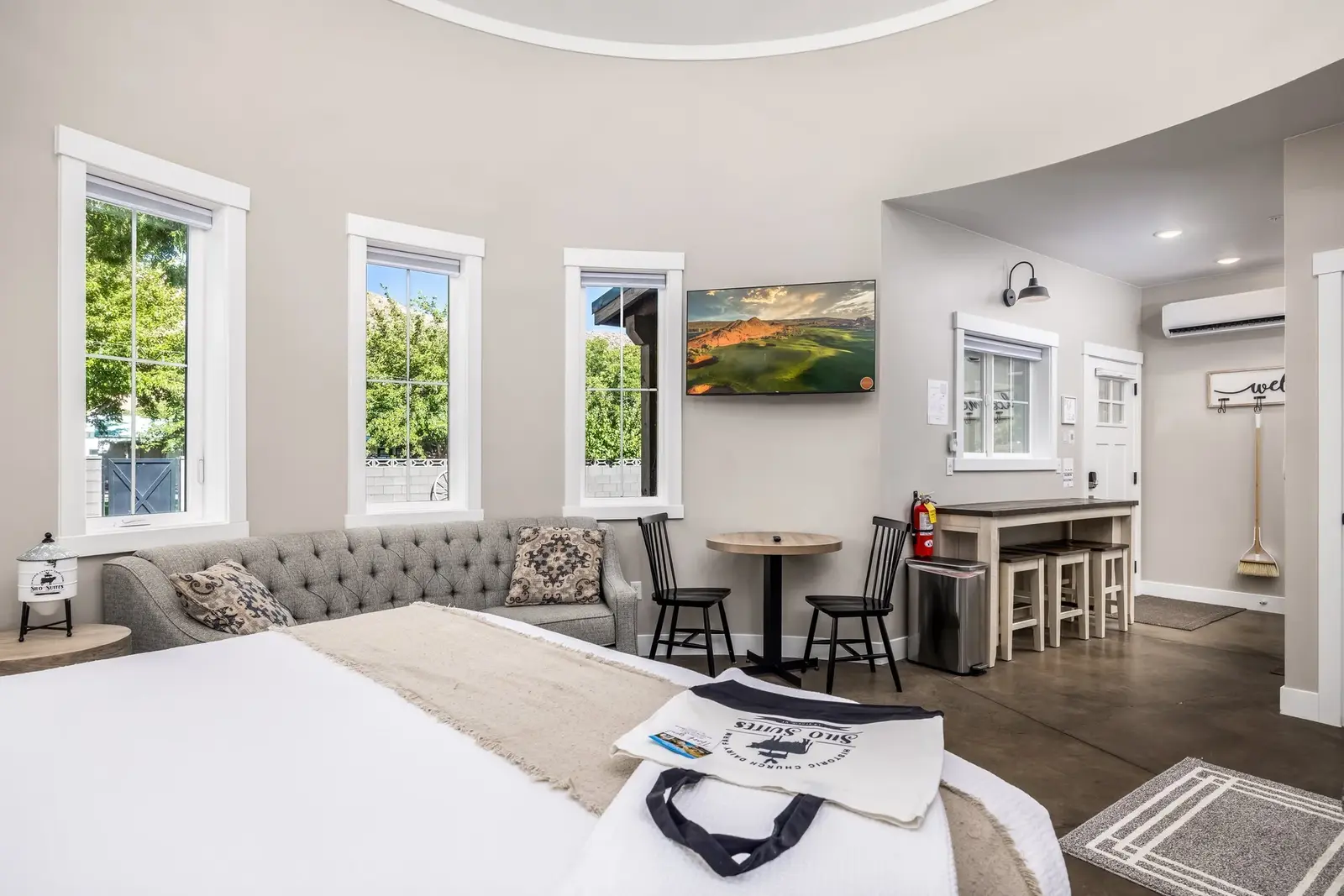 Curved guest suite interior with dining table and sitting area at The Silo Suites