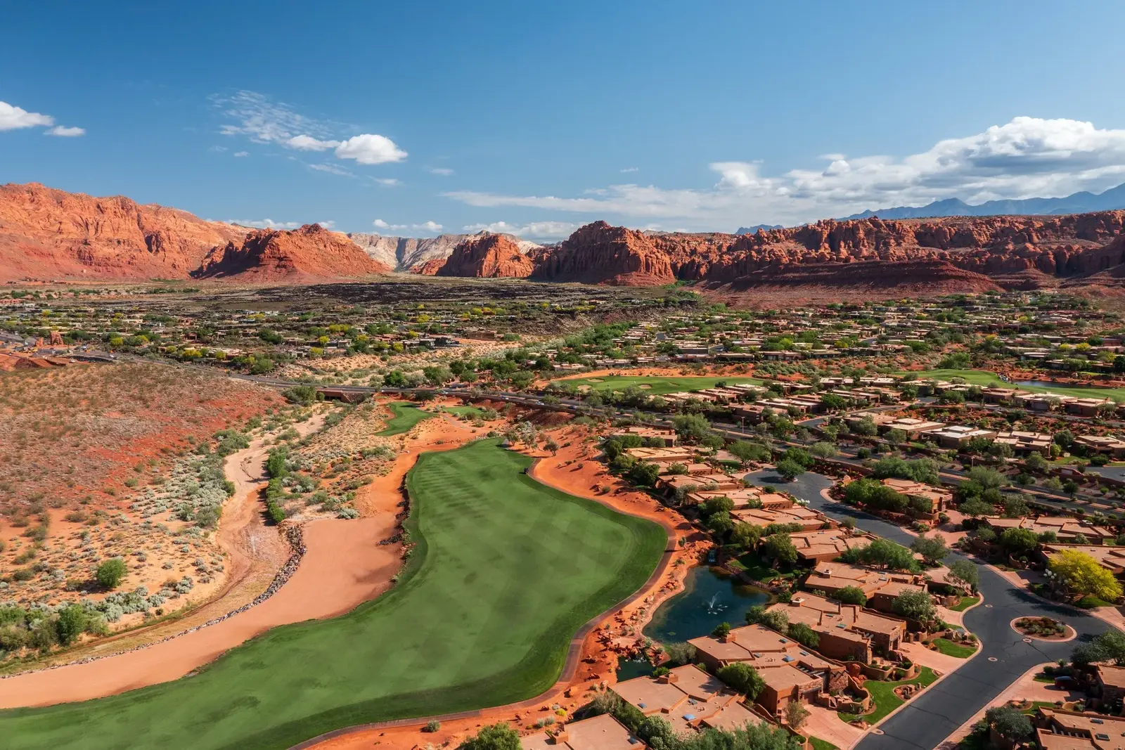 Aerial view of a golf fairway and surrounding red-rock landscape at Entrada