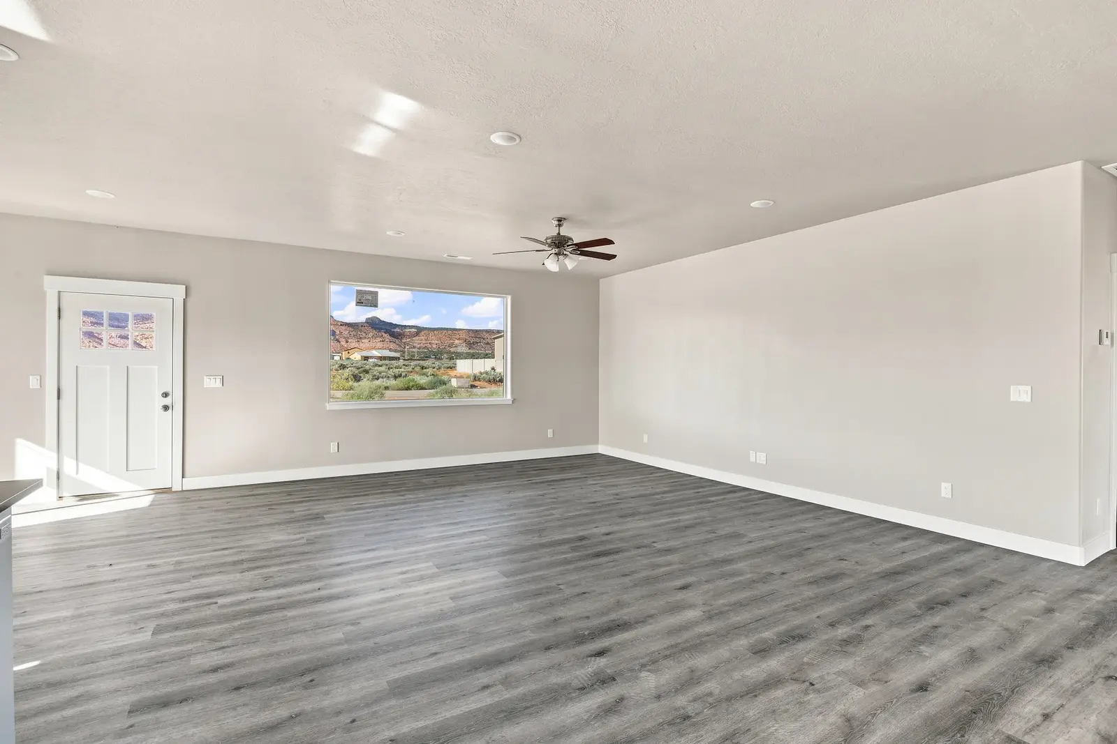 Sam Reed HDR photography: unfurnished living room with desert cliffs visible through the window